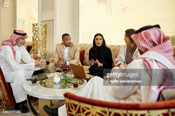 business team meeting informally in riyadh hotel - middle east business people stock pictures, royalty-free photos & images