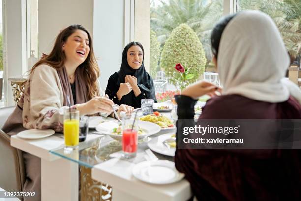 riyadh businesswomen enjoying lunch and conversation - saudi relaxing stock pictures, royalty-free photos & images