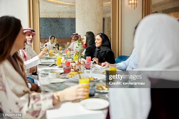 businesspeople enjoying meal in luxury hotel restaurant - saudi lunch stock pictures, royalty-free photos & images