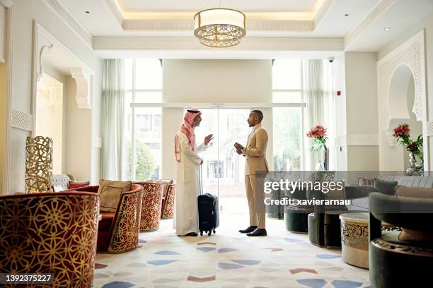 business associates in lobby of saudi luxury hotel - ksa people stock pictures, royalty-free photos & images