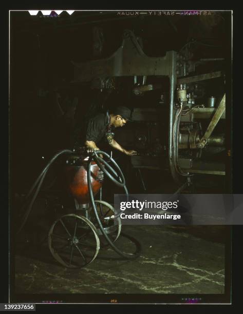 Greasing a locomotive in the roundhouse, 1943.