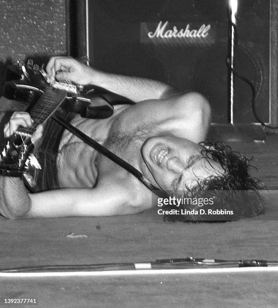 Tighter crop and straightened view of AC/DC guitarist lying on stage while performing at the Palladium in New York City, August 24, 1977. The...
