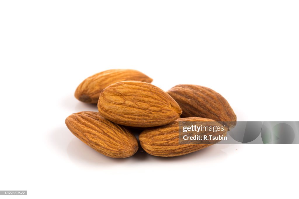 Pile of almonds nuts on a white background
