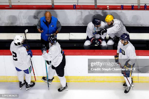 Head Coach Grant Fuhr of Team D talks with Matt Petgrave and Matt Salhany during a 3ICE Hockey tryout session at the Orleans Arena on April 19, 2022...