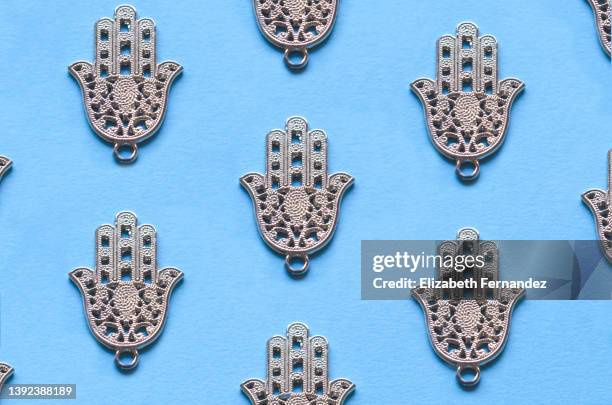 seamless pattern of hamsa hand on blue background - hand of fatima stock pictures, royalty-free photos & images