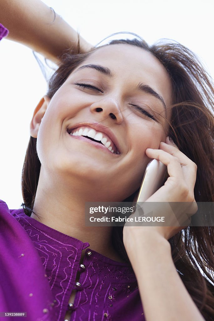 Close-up of a young woman talking on a mobile phone