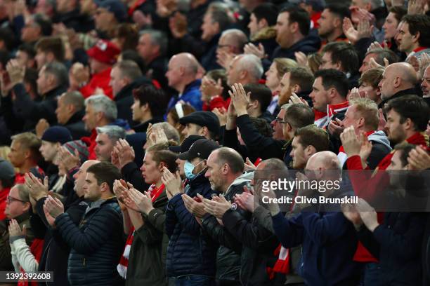 Liverpool fans applaud during the Premier League match between Liverpool and Manchester United at Anfield on April 19, 2022 in Liverpool, England.