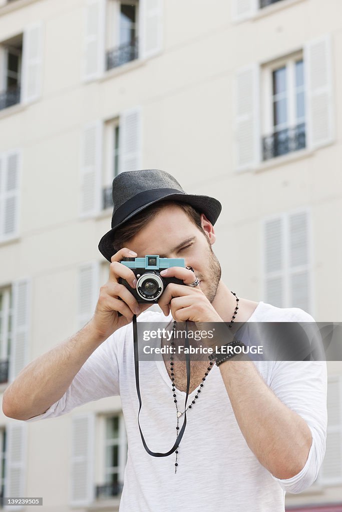 Man taking a picture with a camera, Paris, Ile-de-France, France