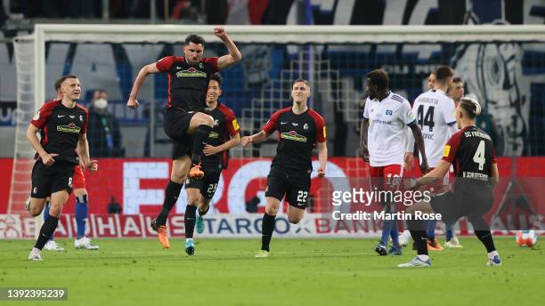Vincenzo Grifo of SC Freiburg celebrates with teammates after scoring their side's third goal from a penalty during the DFB Cup semi final match...