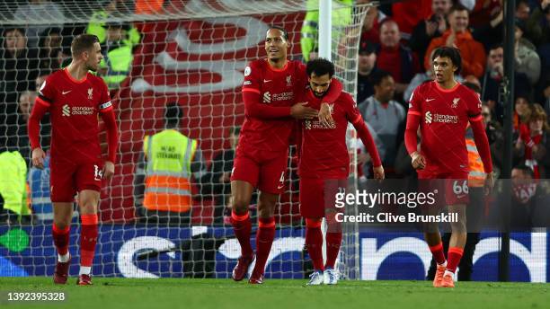 Virgil van Dijk celebrates with Mohamed Salah of Liverpool after scoring their side's second goal during the Premier League match between Liverpool...