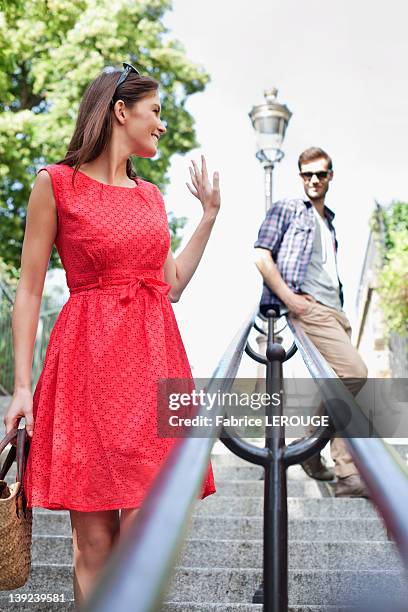 woman waving to her husband, montmartre, paris, ile-de-france, france - waving hands goodbye photos et images de collection