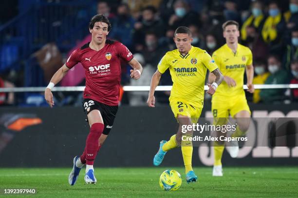 Jesus Vazquez of Valencia CF is challenged by Yeremi Pino of Villarreal CF during the LaLiga Santander match between Villarreal CF and Valencia CF at...