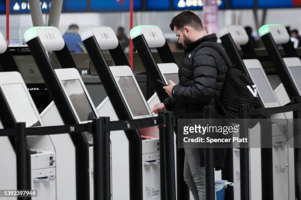 Traveler stands at a kiosk inside John F. Kennedy Airport on April 19, 2022 in New York City. On Monday, a federal judge in Florida struck down the...