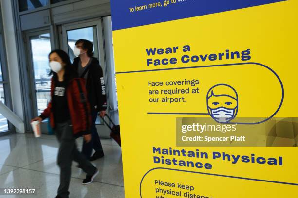 People enter wearing masks at John F. Kennedy Airport on April 19, 2022 in New York City. On Monday, a federal judge in Florida struck down the mask...