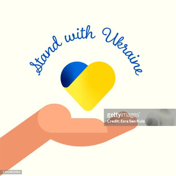 stockillustraties, clipart, cartoons en iconen met stand with ukraine concept vector illustration. a helping hand holding a heart with ukranian flag colors - refugees