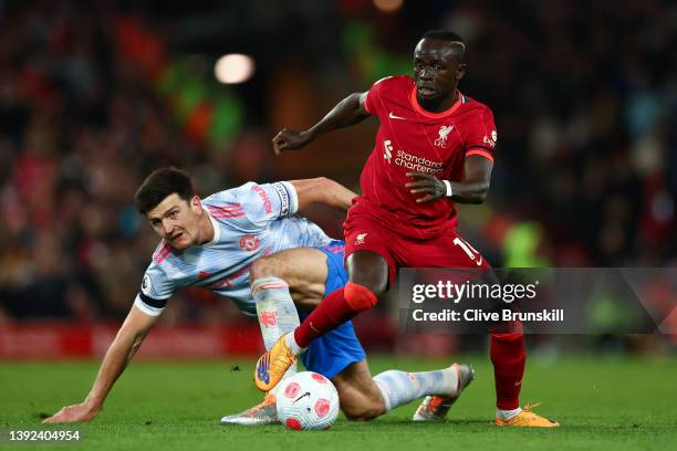 Harry Maguire of Manchester United looks on as Sadio Mane of Liverpool runs with the ball during the Premier League match between Liverpool and...