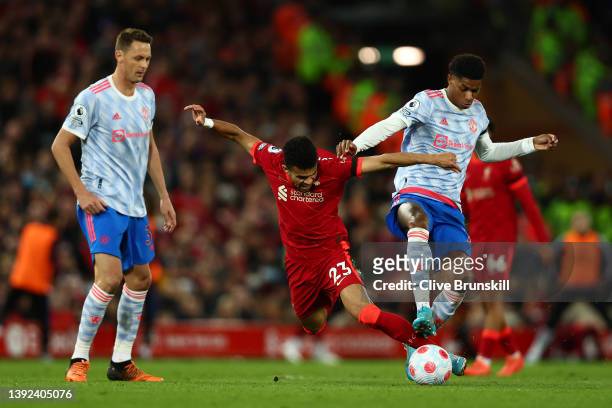 Luis Diaz of Liverpool challenges Marcus Rashford of Manchester United during the Premier League match between Liverpool and Manchester United at...