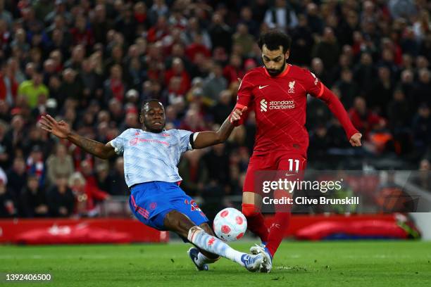 Mohamed Salah of Liverpool scores their side's fourth goal whilst under pressure from Aaron Wan-Bissaka of Manchester United during the Premier...