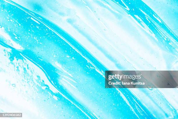 blue transparent texture of moisture serum for face. hydrating hyaluronic acid. antibacterial gel. cosmetic products for makeup and skin care. toothpaste. - toothpaste stock pictures, royalty-free photos & images