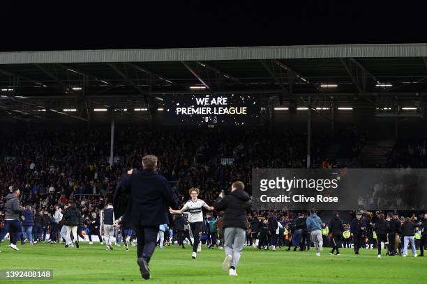General view of a LED Board the inside of Craven Cottage which displays the message "We Are Premier League" as Fulham fans invade the pitch as they...