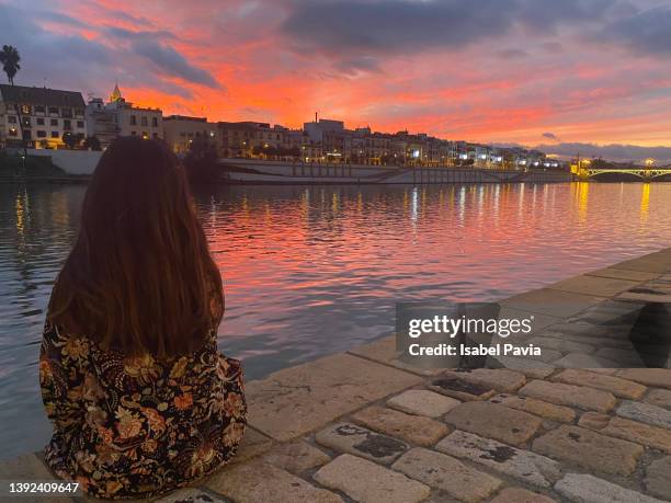 young woman enjoying sunset in seville, spain - seville landscape stock pictures, royalty-free photos & images