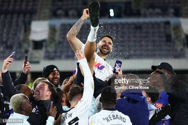 Players of Fulham lift Aleksandar Mitrovic as they celebrate their side's promotion to the Premier League following victory in the Sky Bet...