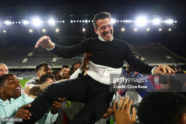 Players of Fulham lift Marco Silva, Manager of Fulham, as they celebrate their side's promotion to the Premier League following victory in the Sky...