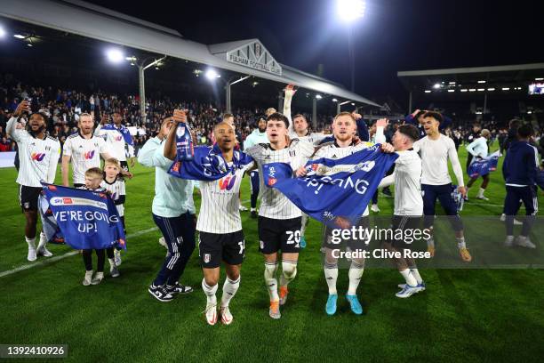 Bobby Reid, Neco Williams and Harrison Reed of Fulham celebrate their side's promotion to the Premier League following victory in the Sky Bet...
