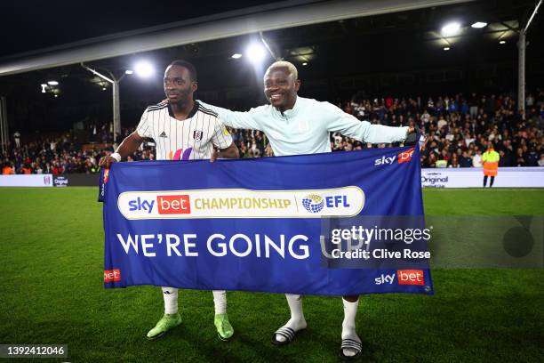 Neeskens Kebano and Jean Michael Seri of Fulham celebrate their side's promotion to the Premier League following victory in the Sky Bet Championship...