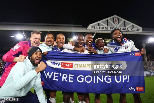 Fulham players celebrate their side's promotion to the Premier League following victory in the Sky Bet Championship match between Fulham and Preston...