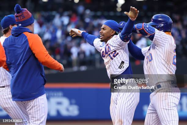 Francisco Lindor of the New York Mets celebrates with teammates after hitting a walk-off single during the tenth inning of the game against the San...