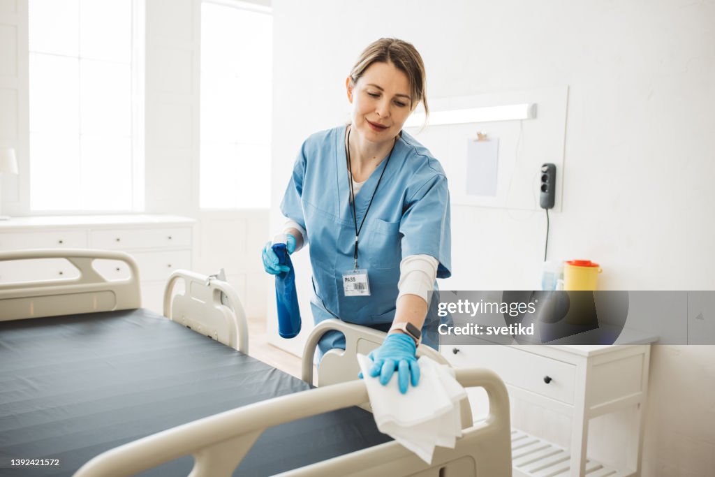Nurse cleaning hospital ward.