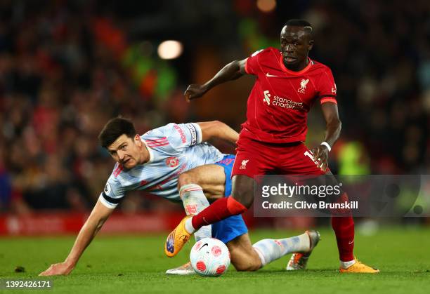 Harry Maguire of Manchester United looks on as Sadio Mane of Liverpool runs with the ball during the Premier League match between Liverpool and...