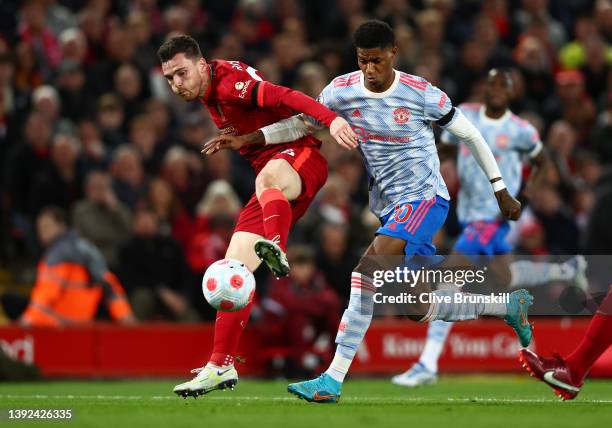 Andy Robertson of Liverpool under pressure from Marcus Rashford of Manchester United during the Premier League match between Liverpool and Manchester...