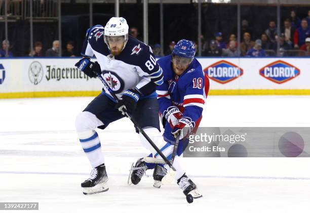 Andrew Copp of the New York Rangers steals the puck from Pierre-Luc Dubois of the Winnipeg Jets during the first period at Madison Square Garden on...