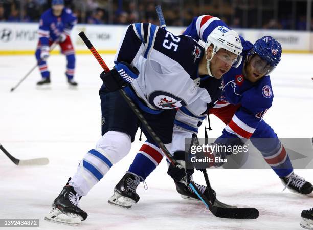 Paul Stastny of the Winnipeg Jets and Andrew Copp of the New York Rangers face off during the second period at Madison Square Garden on April 19,...