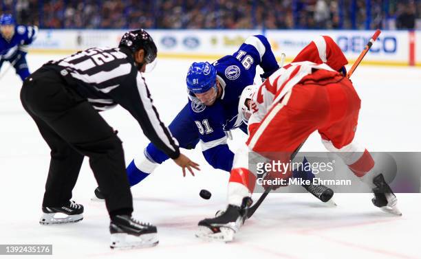 Steven Stamkos of the Tampa Bay Lightning and Michael Rasmussen of the Detroit Red Wings face off in the second period during a game at Amalie Arena...