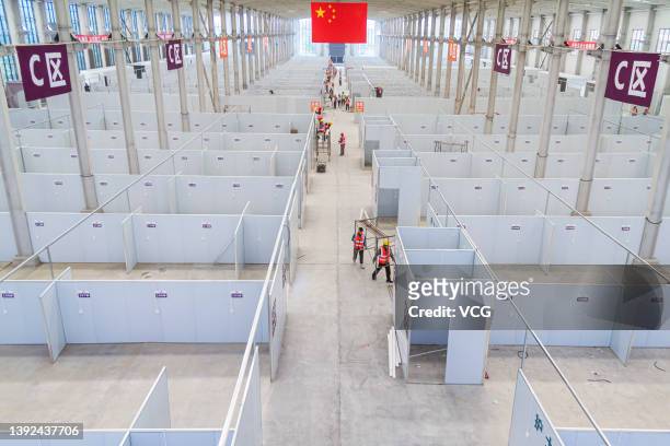 Workers set up a 1,032-bed makeshift hospital for COVID-19 patients on April 19, 2022 in Yuncheng, Shanxi Province of China.