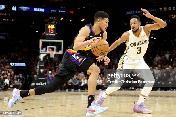 Devin Booker of the Phoenix Suns drives the ball against CJ McCollum of the New Orleans Pelicans during the first half of Game Two of the Western...