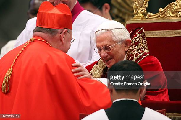 New cardinal Timothy Michael Dolan, Archbishop of New York, receives the biretta cap from Pope Benedict XVI in Saint Peter's Basilica on February 18,...