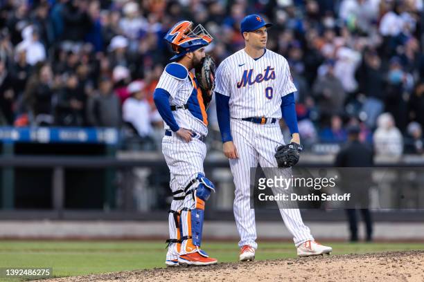 Adam Ottavino of the New York Mets and Tomas Nido of the New York Mets meet on the mound during the tenth inning of the game against the San...