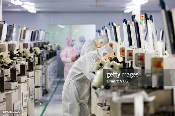 Employees work at a chip manufacturing company on April 19, 2022 in Suqian, Jiangsu Province of China.