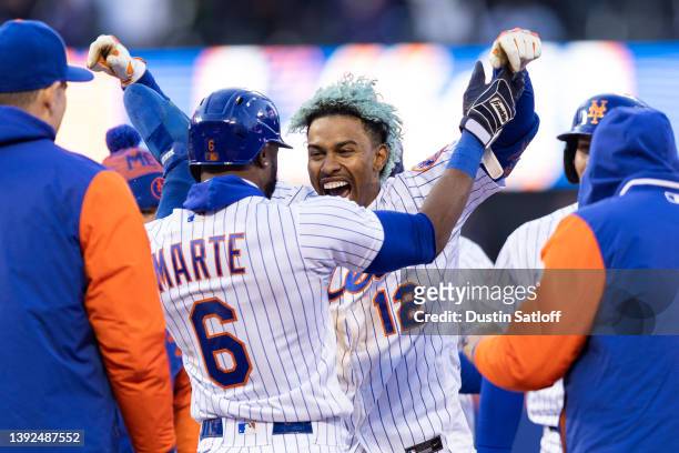 Francisco Lindor of the New York Mets celebrates with Starling Marte of the New York Mets after hitting a walk-off single during the tenth inning of...