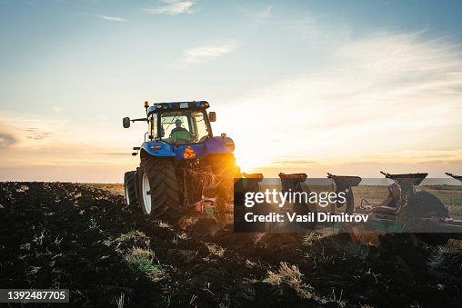 Farmer in tractor preparing land with seedbed cultivator