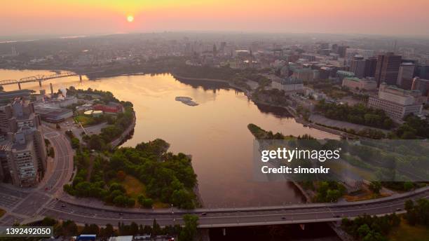 view of ottawa river with modern skyscrapers - ottawa city stock pictures, royalty-free photos & images