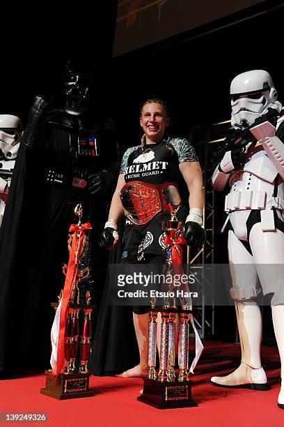 Amanda Lucas, daughter of film director George Lucas and the new DEEP women's open weight champion poses for photographs with the trophies, Star Wars...