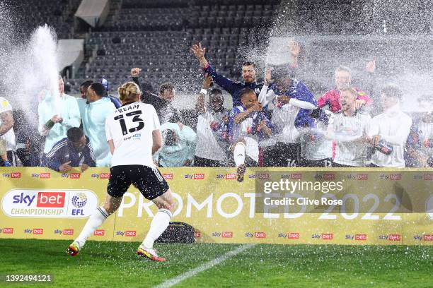 Fulham players celebrate their side's promotion to the Premier League following victory the Sky Bet Championship match between Fulham and Preston...