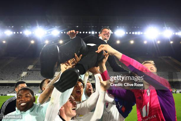 Players of Fulham lift Marco Silva, Manager of Fulham, as they celebrate their side's promotion to the Premier League following victory in the Sky...