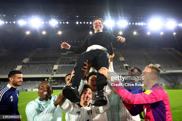 Players of Fulham lift Marco Silva, Manager of Fulham, as they celebrate their side's promotion to the Premier League following victory in the Sky...