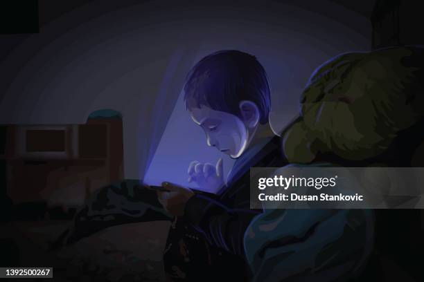 the boy plays games at night - children playing video games on sofa stock illustrations